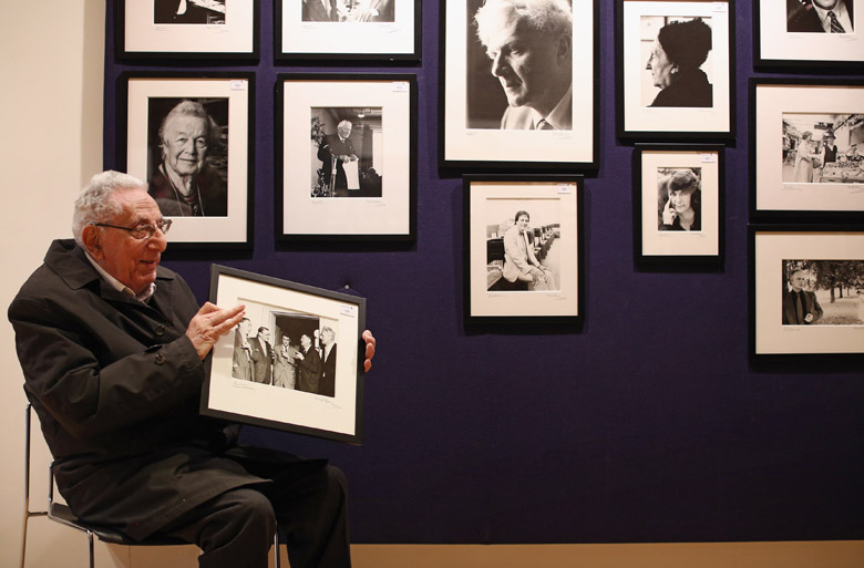 Photographer Mark Gerson, 92, poses for a picture with a selection of his images of writers in Bonhams auction house on April 8, 2013 in London/Getty